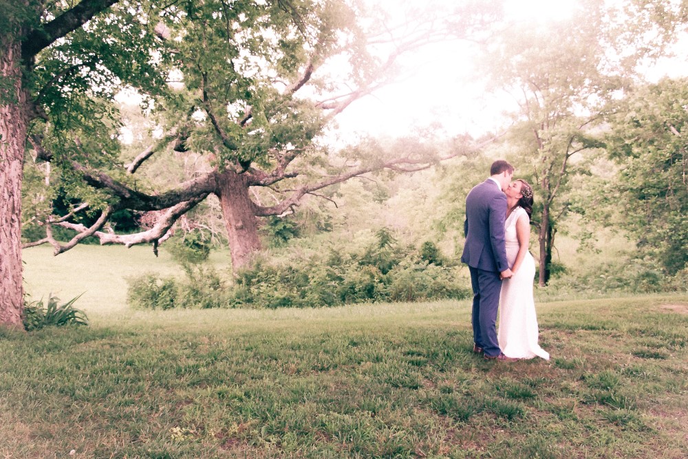 Wedding Look Book at Mountain Run Winery: Couple kissing by oak tree