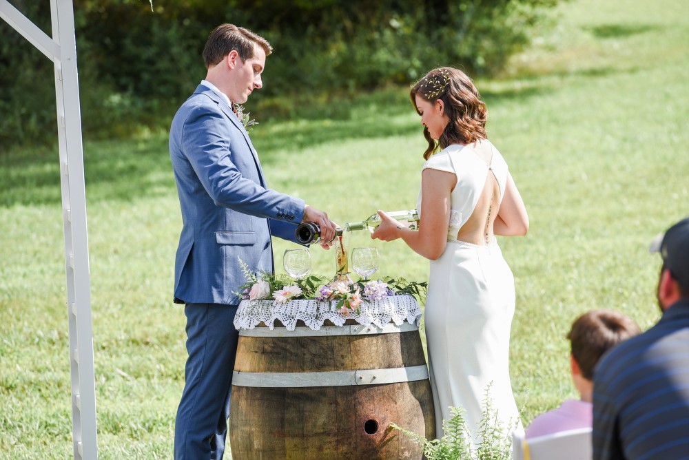 Weddings Wedding Look Book at Mountain Run Winery: Bride and groom pouring wine into a decanter during the ceremony