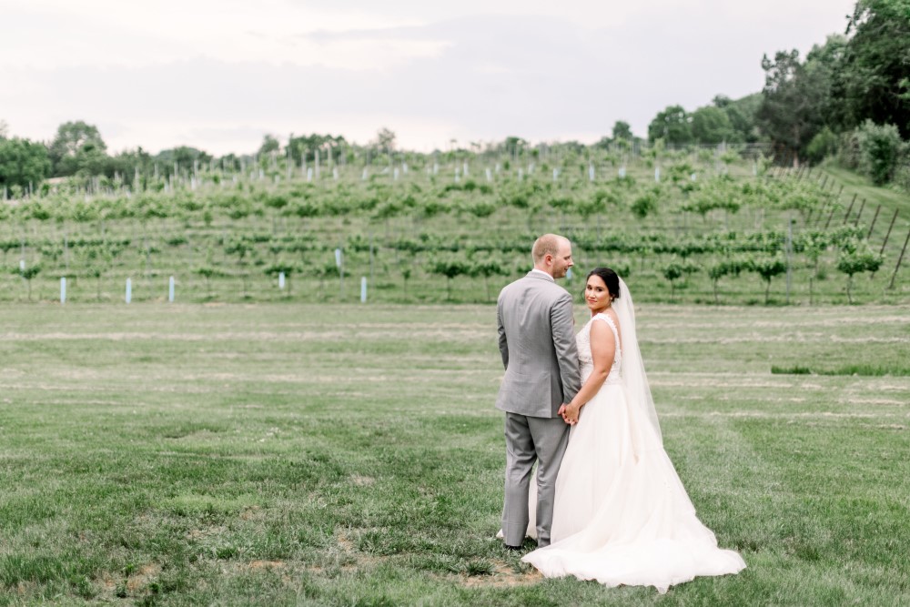 Wedding Look Book at Mountain Run Winery: Couple standing with vineyard backdrop