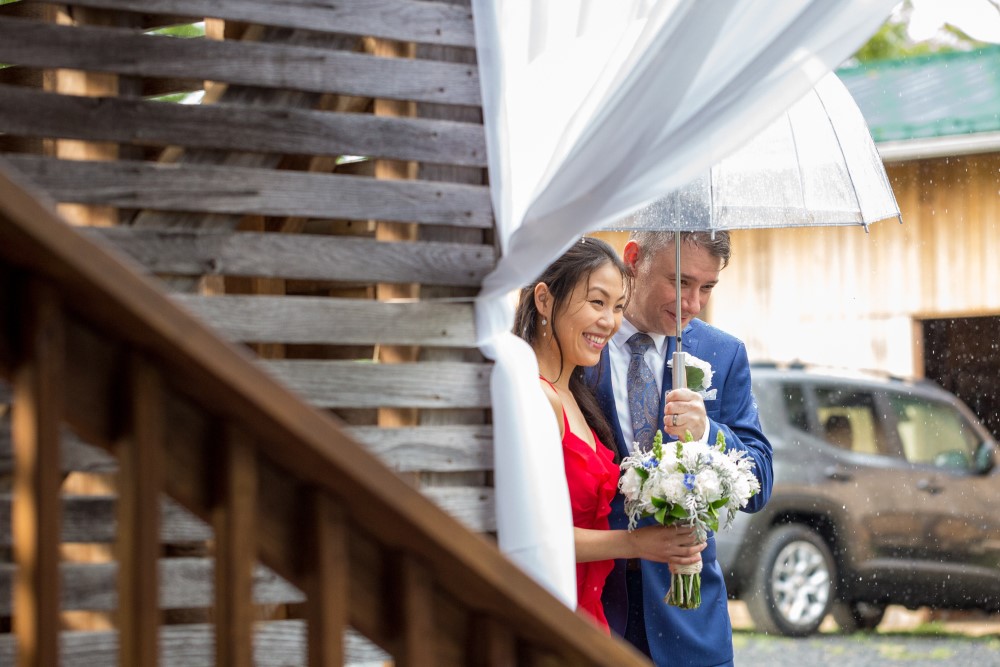 Weddings Wedding Look Book at Mountain Run Winery: Couple entering barn during rainstorm