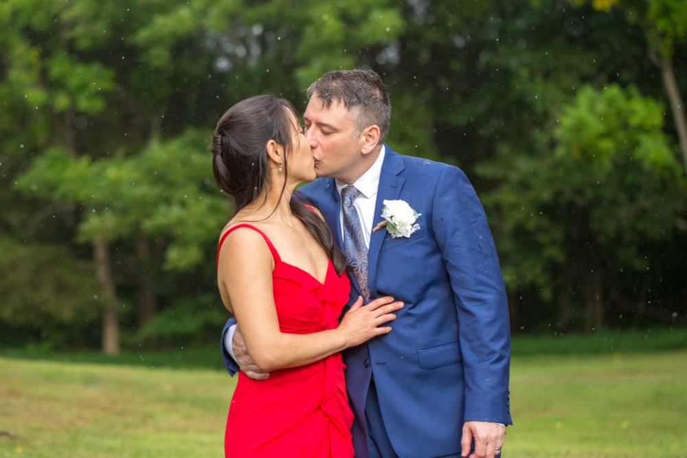 Wedding Look Book at Mountain Run Winery: Couple kissing in the rain