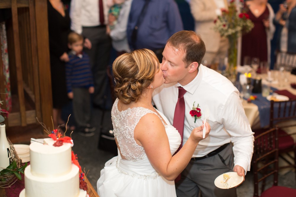 Wedding Look Book at Mountain Run Winery: Couple kissing after cake cutting