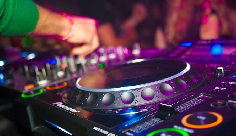 Image of a dj turntable and hands at controls