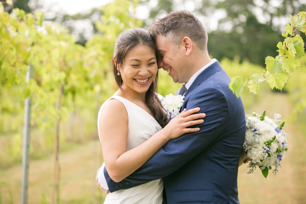Wedding Look Book at Mountain Run Winery: Couple kissing in vineyard