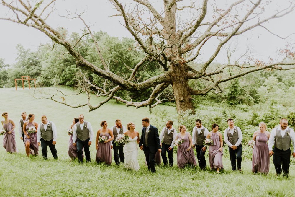 Wedding Look Book at Mountain Run Winery: Wedding party walking under a tree