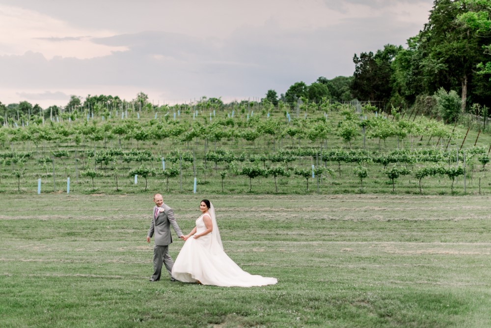 Wedding Look Book at Mountain Run Winery: Couple walking near vineyard