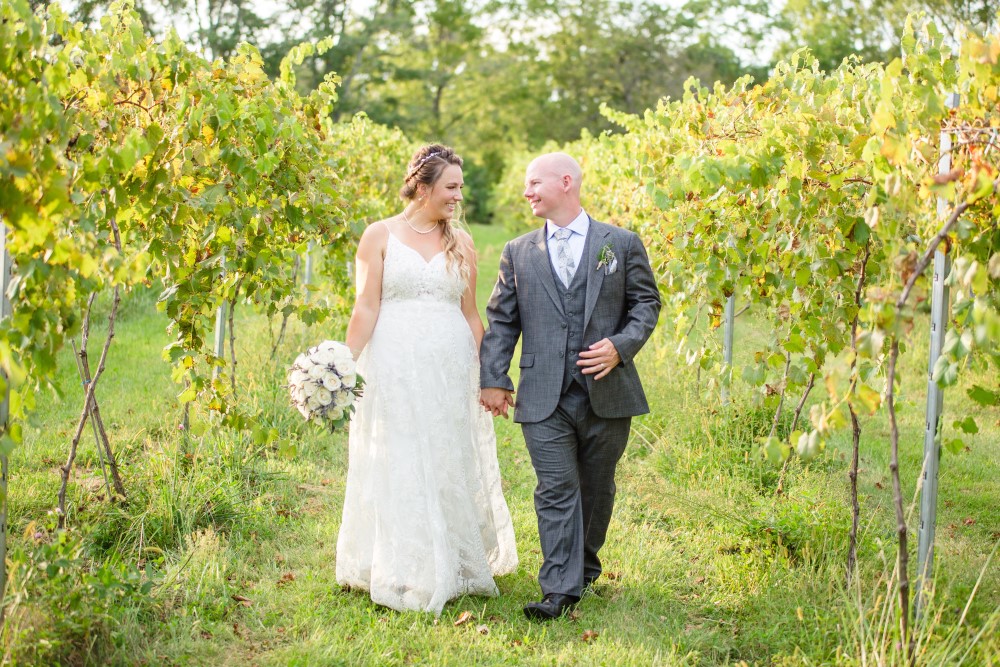 Wedding Look Book at Mountain Run Winery: Couple walking in vineyard